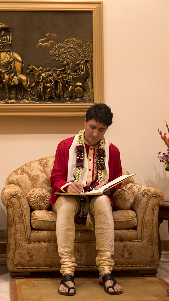 PM Justin Trudeau signs the visitor's book