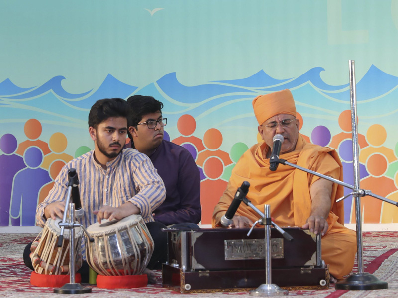Sadhus sing kirtans in the assembly