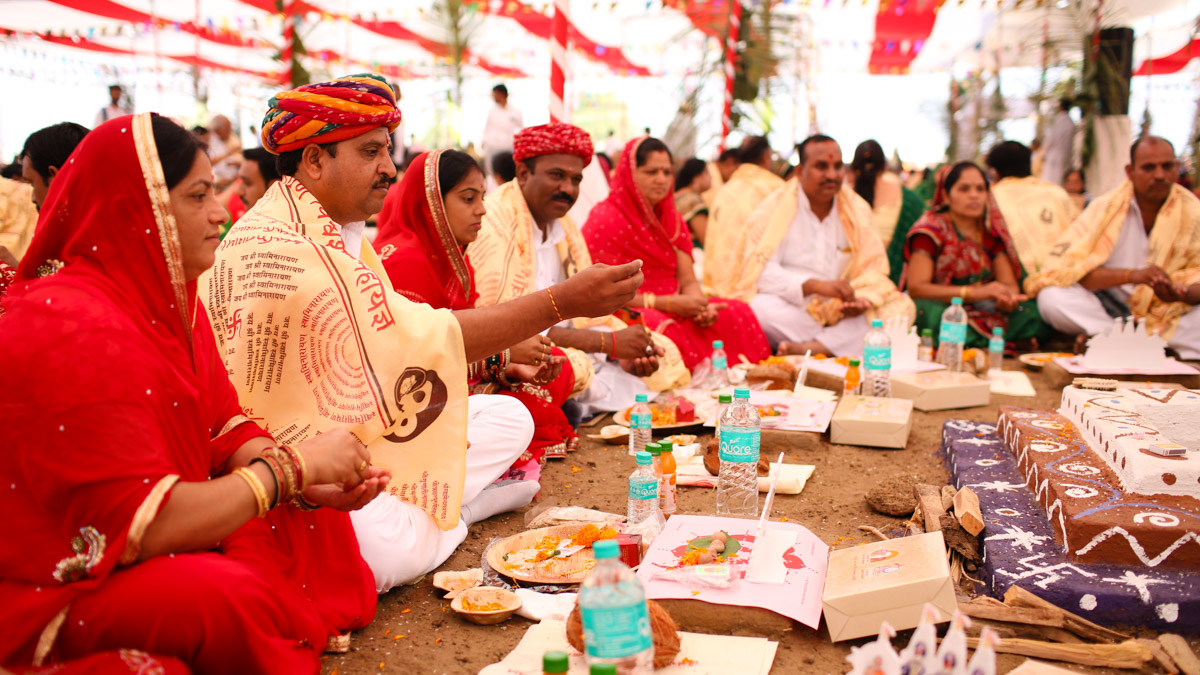 Devotees participate in yagna rituals