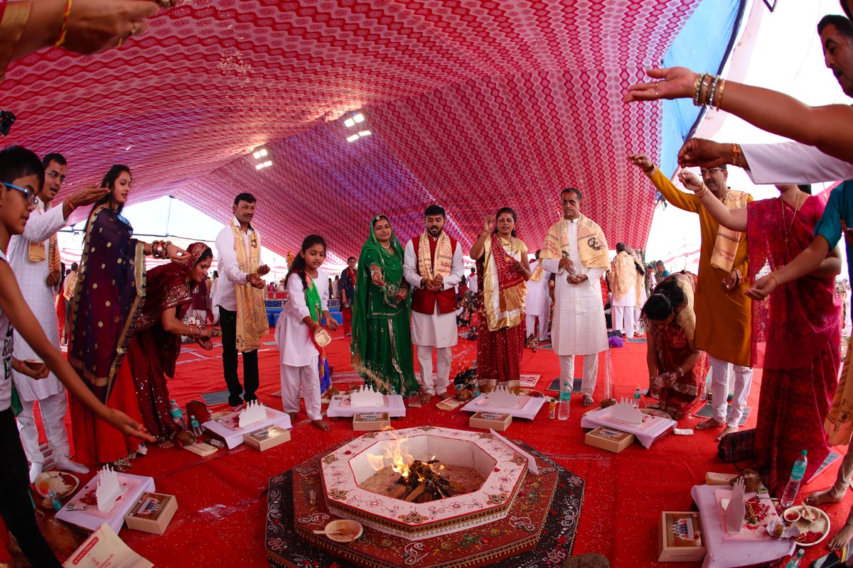 Devotees participate in yagna rituals