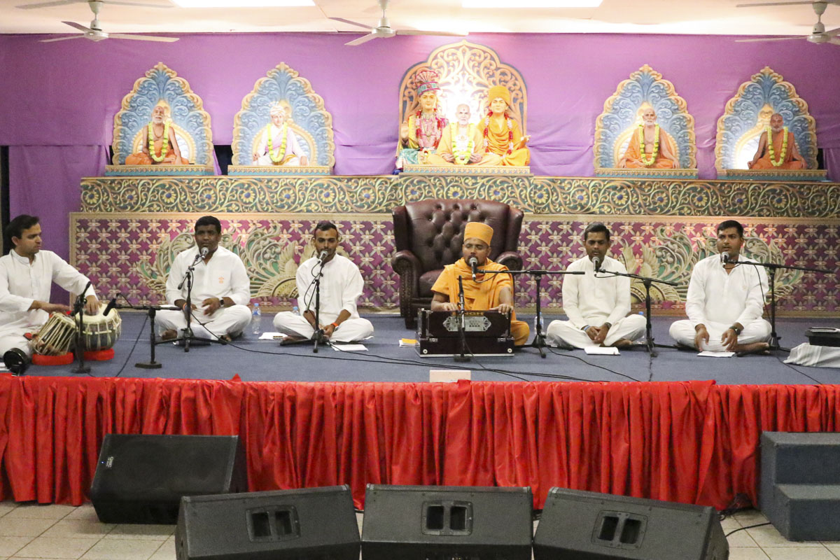 Sadhus and youths sing kirtans in the assembly