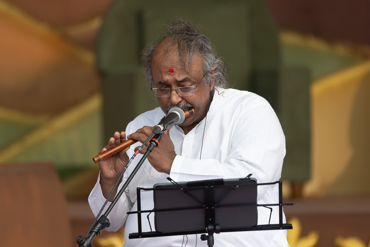 A devotee plays the flute
