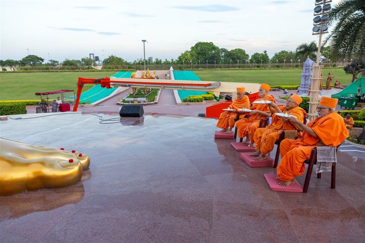 Senior swamis perform the arti