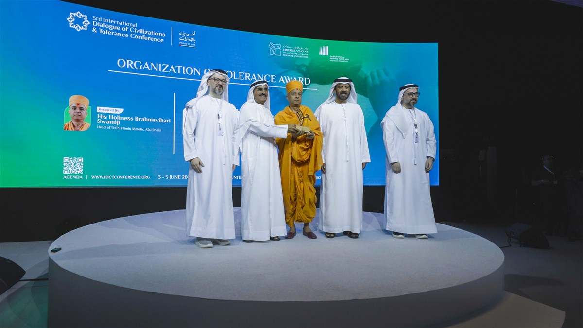 Swami Brahmaviharidas accepts the honour from the hands of HE Dr. Abdulla Belhaif Al Nuaimi, Chancellor of Emirates Scholar Center for Research and Studies, and HE Dr. Khalifa Al Dhaheri, Chancellor of Mohamed Bin Zayed University for Humanities
